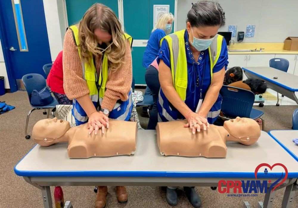 Student practicing hands-on cpr skills with training manikins